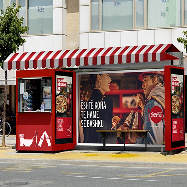 Outdoor advertising bus shelter with vending kiosk