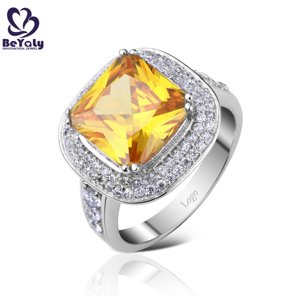 Noble style yellow gemstone silver ring with cz stones