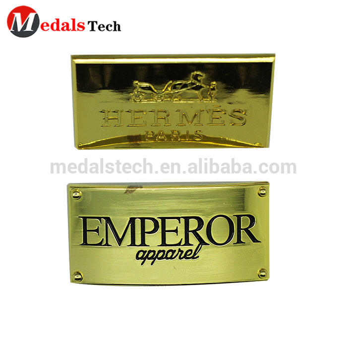 Free sample zinc alloy shiny gold engraving logo design metal labels for handbags