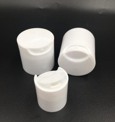 Plastic disk top cap for cosmetic bottle
